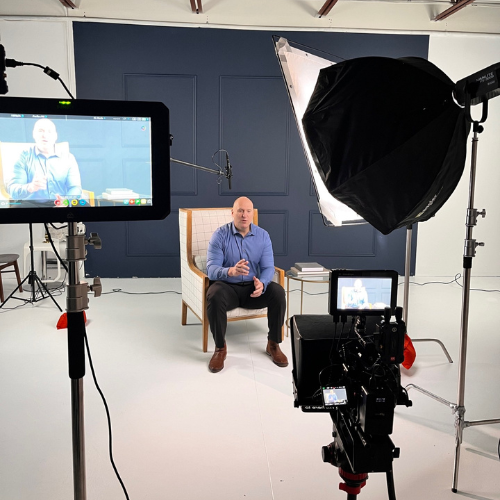 A person sitting in a chair in a photo studio, Clearwater Florida Digital Marketing